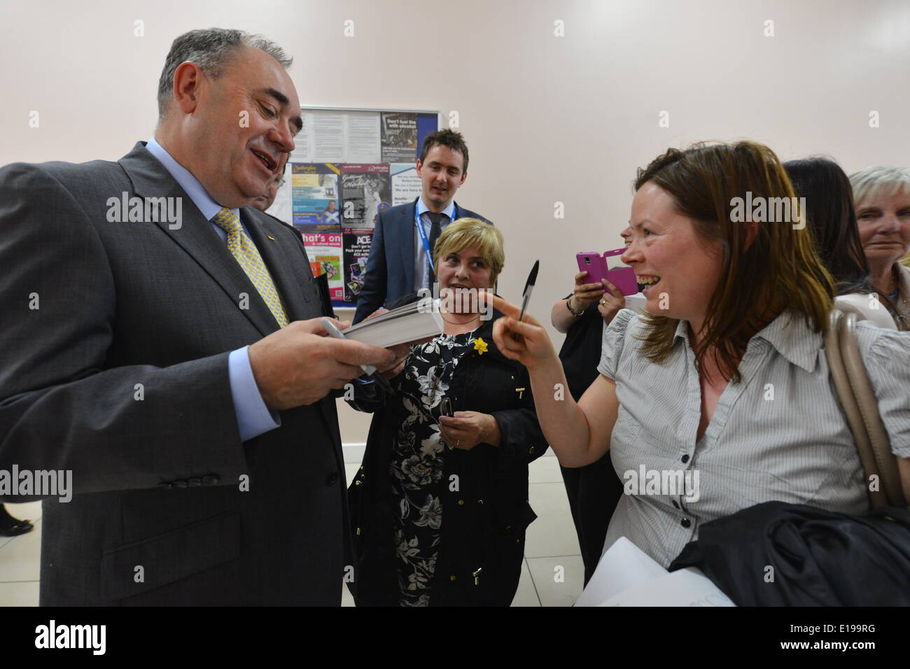 Rutherglen, South Lanarkshire, Scotland, UK. 27th May 2014.  First Minister Alex Salmond  signs autographs after a meeting where members of the public asked questions on Tuesday 27 May 2014 in Rutherglen, South Lanarkshire. The meeting was one in a series being held following publication of 'Scotland's Future' and ahead of the 18 September independence referendum.  © David Gordon/Alamy Live News Stock Photo