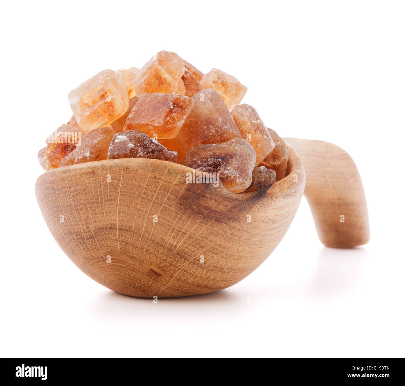Brown cane caramelized lump sugar in wooden bowl isolated on white