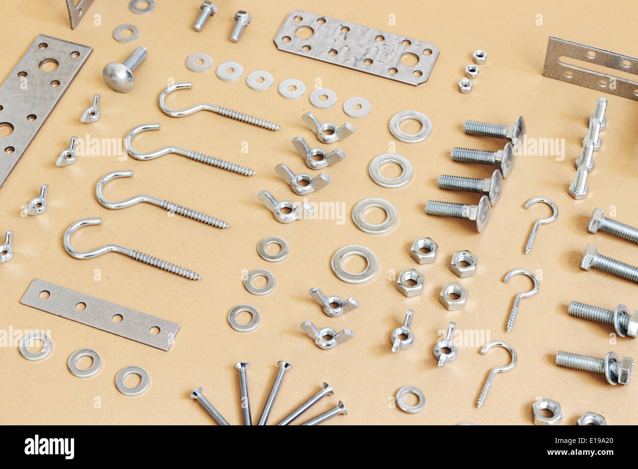 A wide variety of fasteners, spread on paper Stock Photo