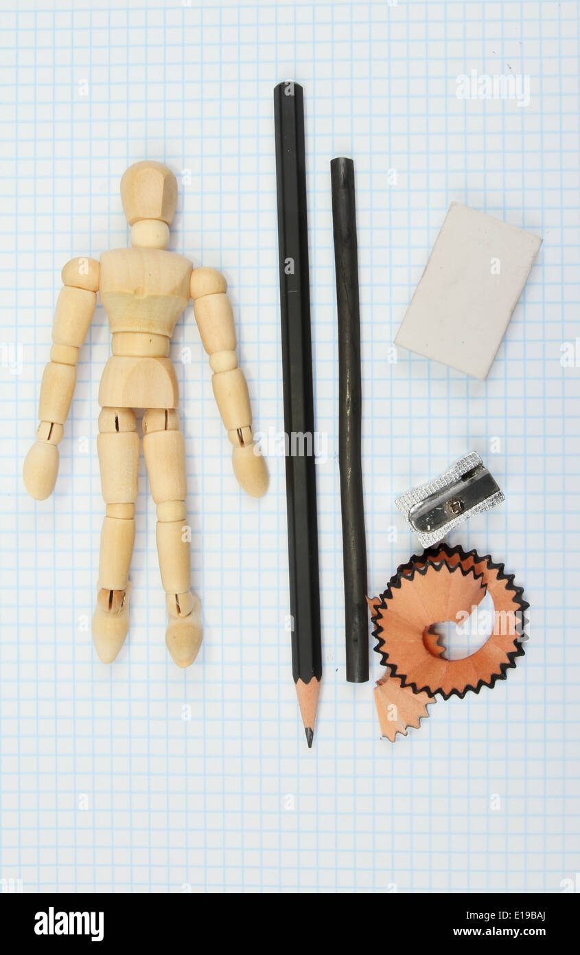 Artists mannikin and drawing materials on graph paper Stock Photo