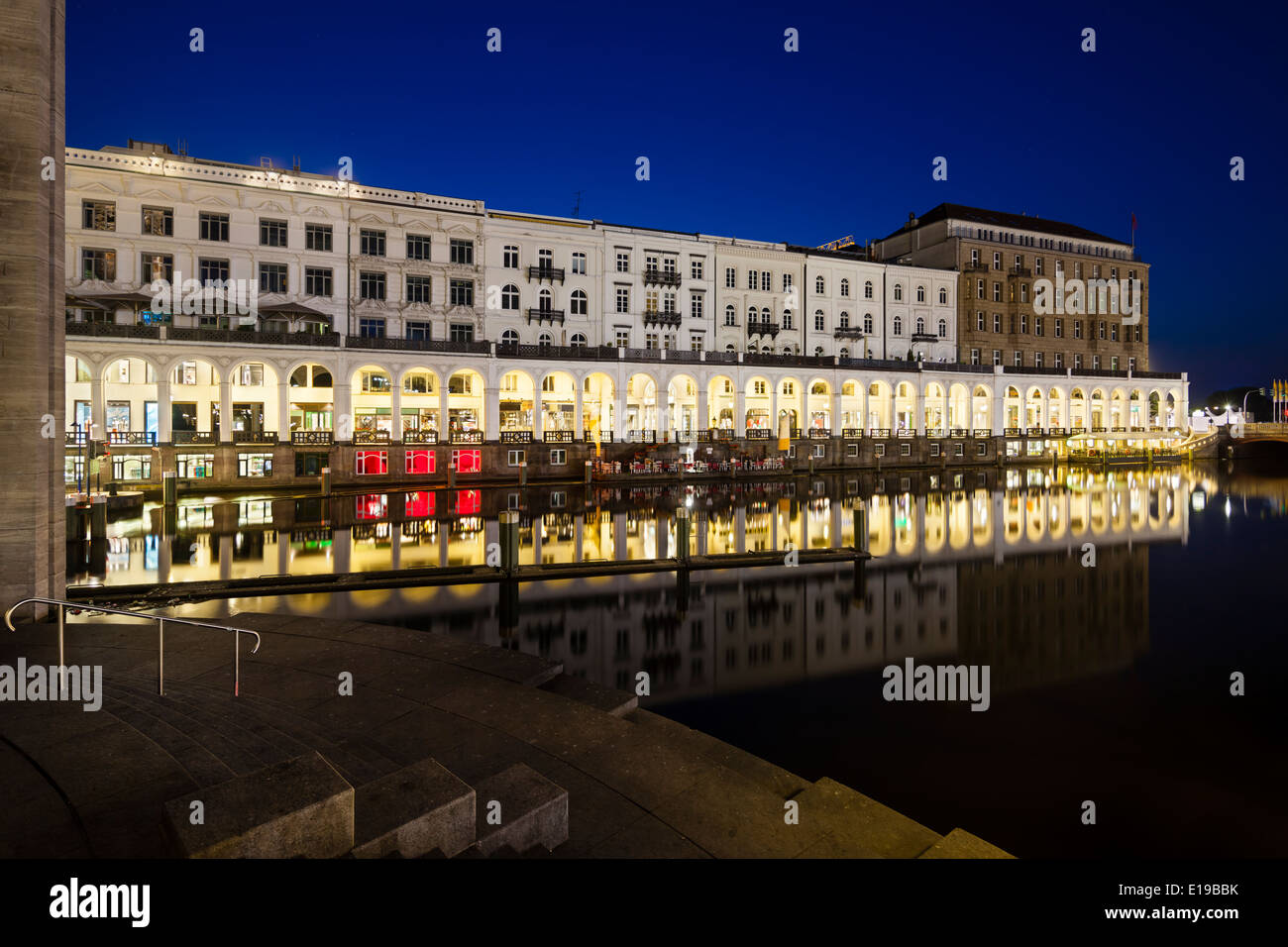 The Alsterarkaden in Hamburg, Germany at night with reflection in a canal Stock Photo