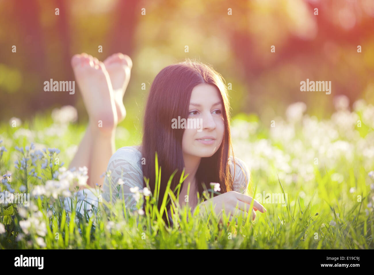 young woman lying on green grass Stock Photo - Alamy