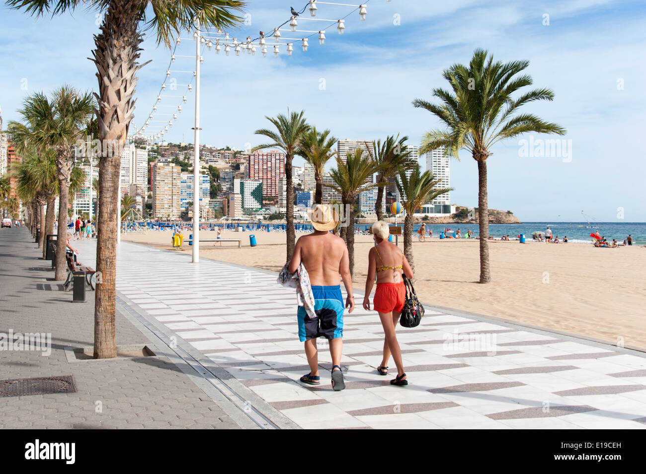 British tourists strolling along the promenade, Benidorm, Costa Blanca, Spain Stock Photo