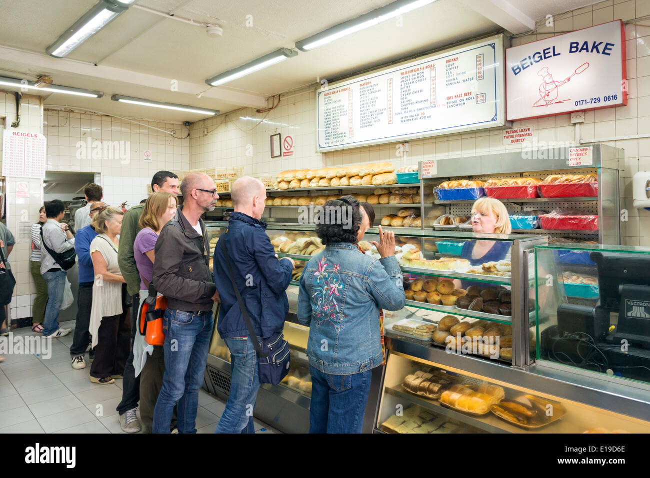 Customers being served in Beigel Bake Brick Lane Bakery, London, England, UK Stock Photo