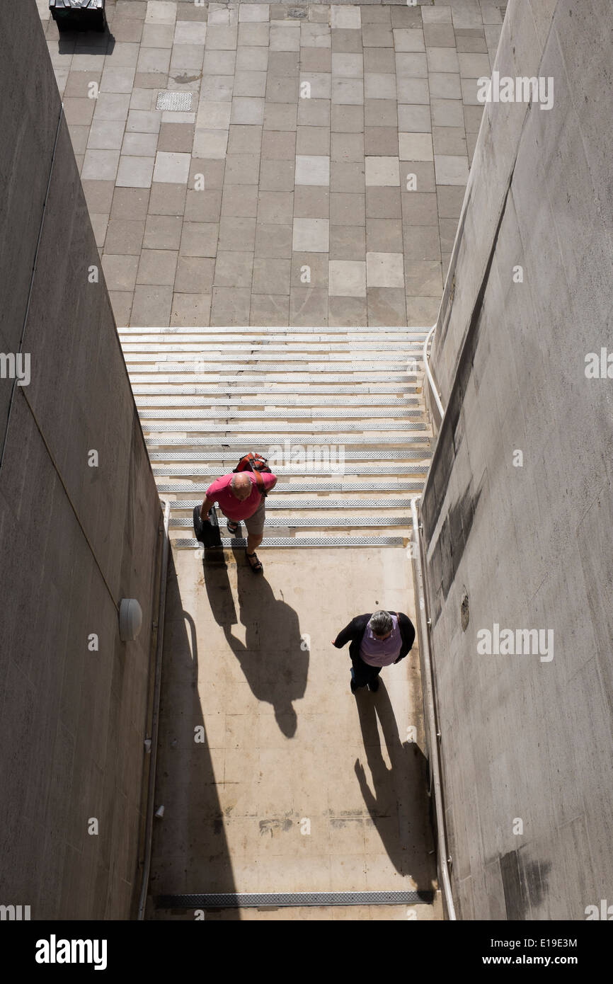 couple climbing steps under waterloo bridge stock photo 69664776