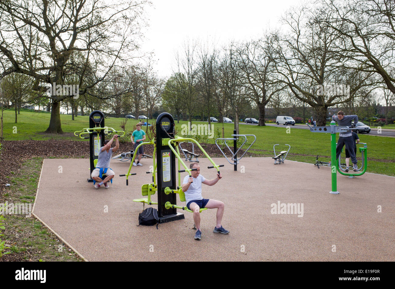People exercising at outdoor gym in Finsbury Park, Haringey, London, England, UK Stock Photo