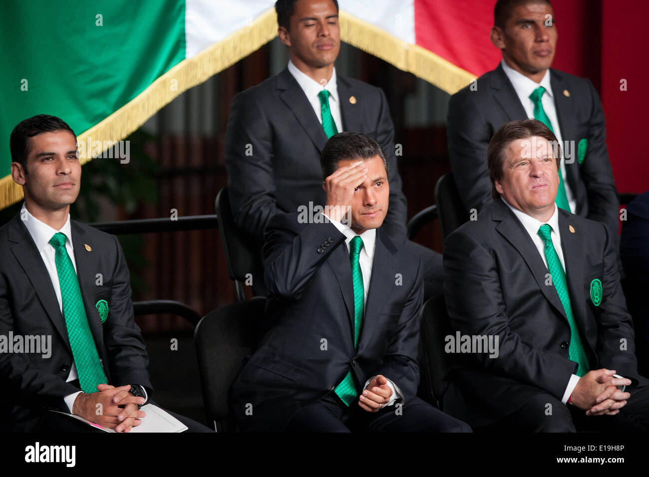 Mexico City, Mexico. 27th May, 2014. Mexico's President Enrique Pena Nieto (C), head coach Miguel Herrera (R) and player Rafael Marquez (L) of Mexico's national soccer team react during the flag ceremony for the 2014 Brazil World Cup in the central patio of the National Palace, in Mexico City, capital of Mexico, on May 27, 2014. Credit:  Pedro Mera/Xinhua/Alamy Live News Stock Photo