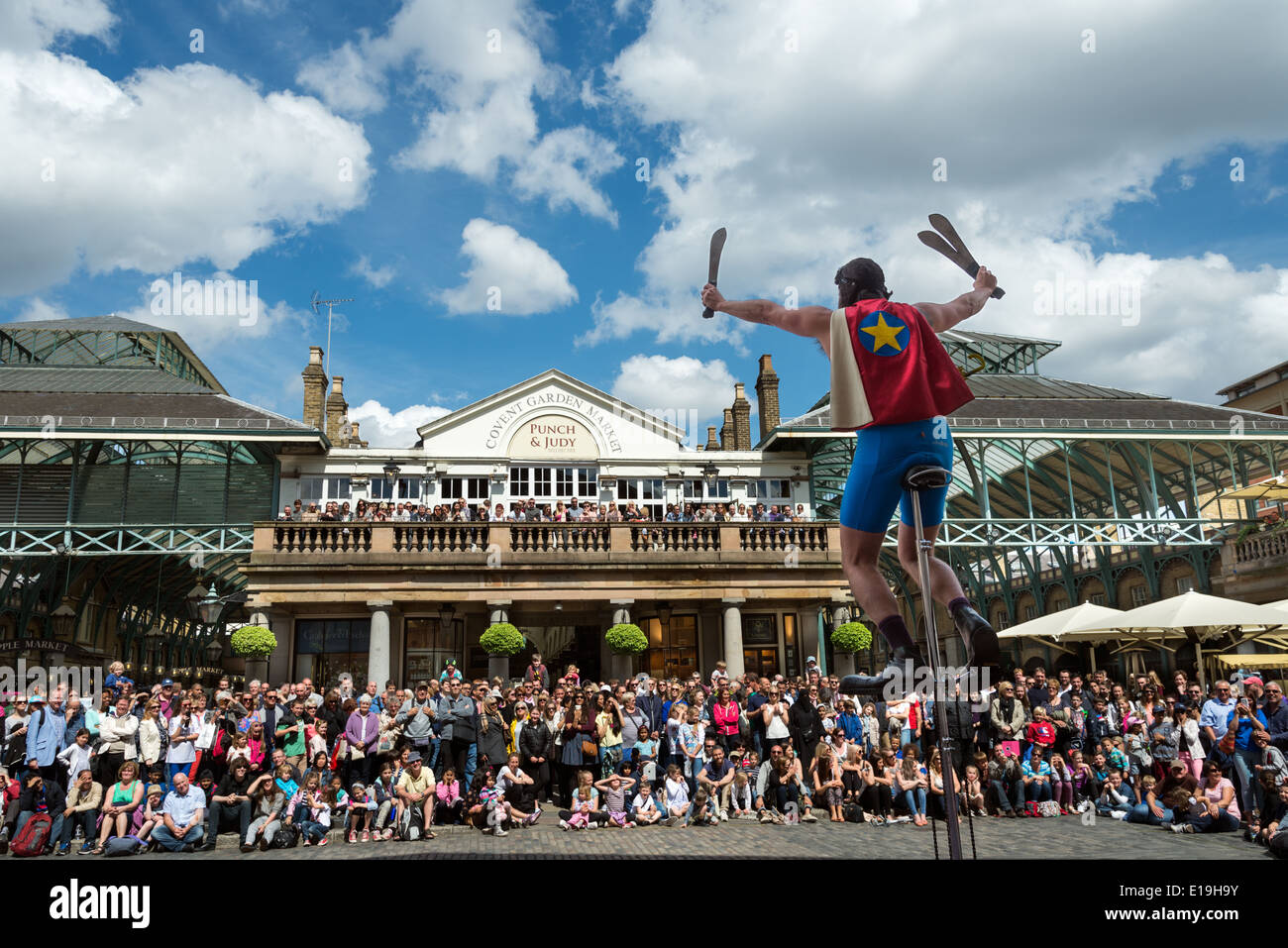 Juggling unicycle performer in Covent Garden, London, UK Stock Photo