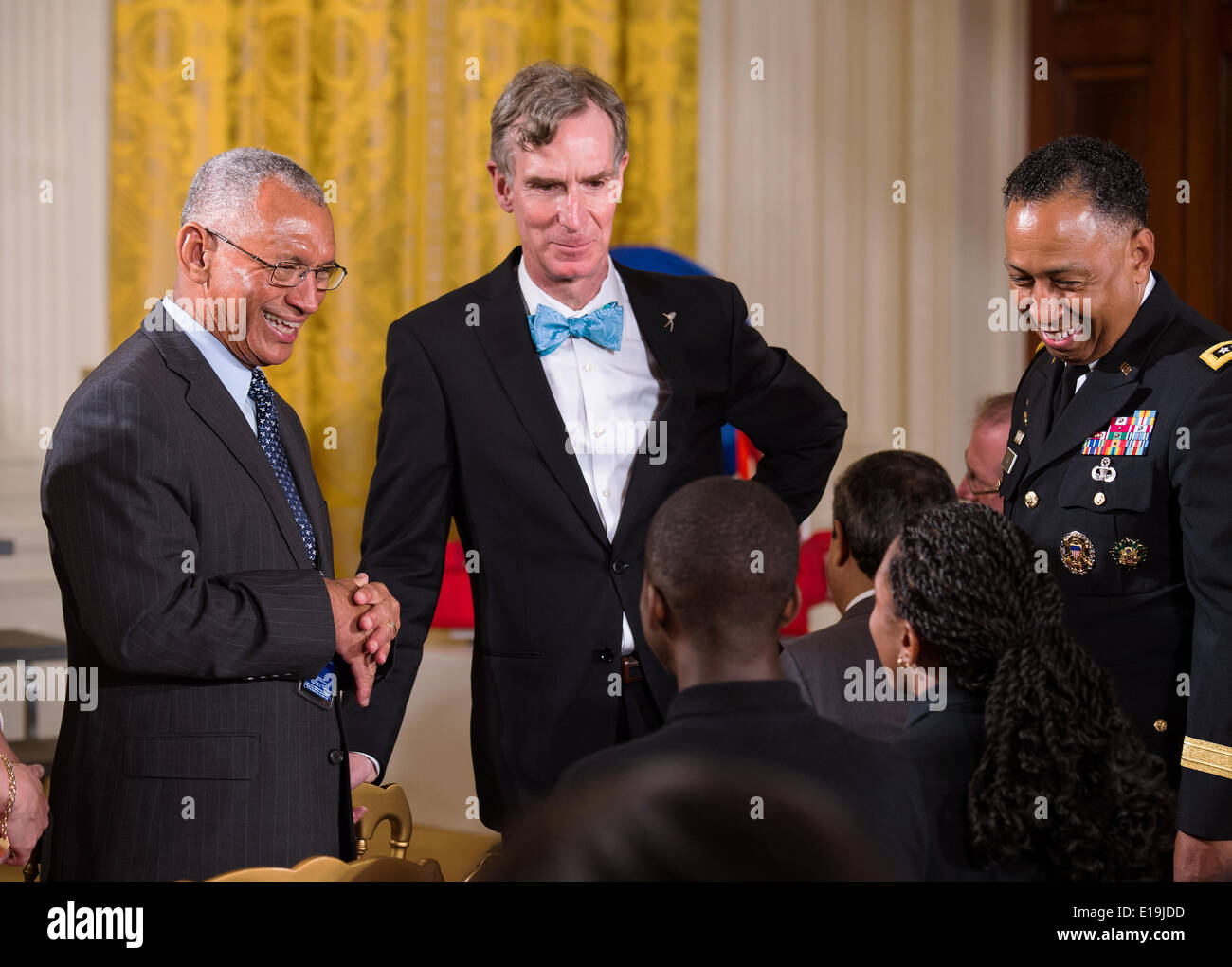NASA Administrator Charles Bolden, left, and Bill Nye, The Science Guy, speak with students participating in the White House Science Fair in the East Room May 27, 2014 in Washington, DC. The event included 100 students from more than 30 different states who competed in science, technology, engineering, and math competitions. Stock Photo