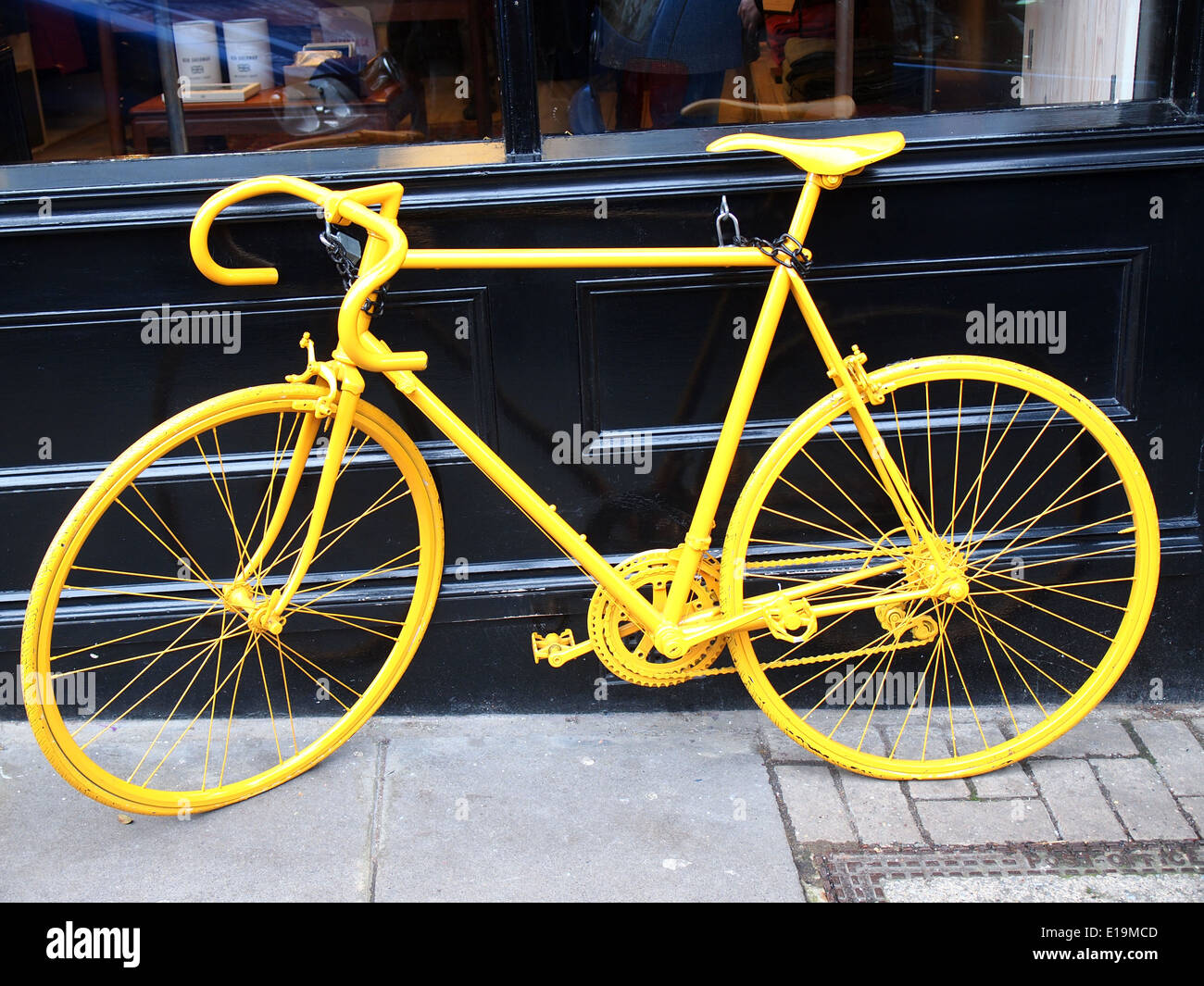 photo of old yellow bike on the window of the coffee shop Stock Photo