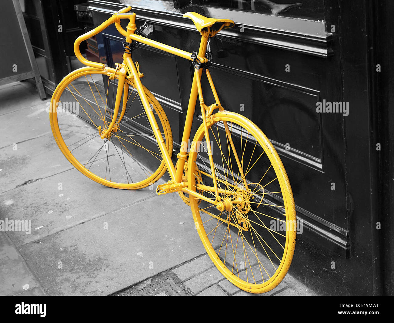 photo of old yellow bike on the window of the coffe shop Stock Photo