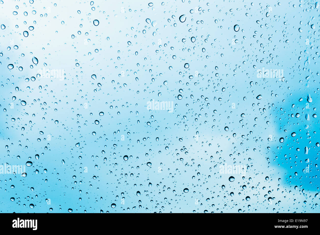Fresh water drops of rain on blue glass background Stock Photo - Alamy