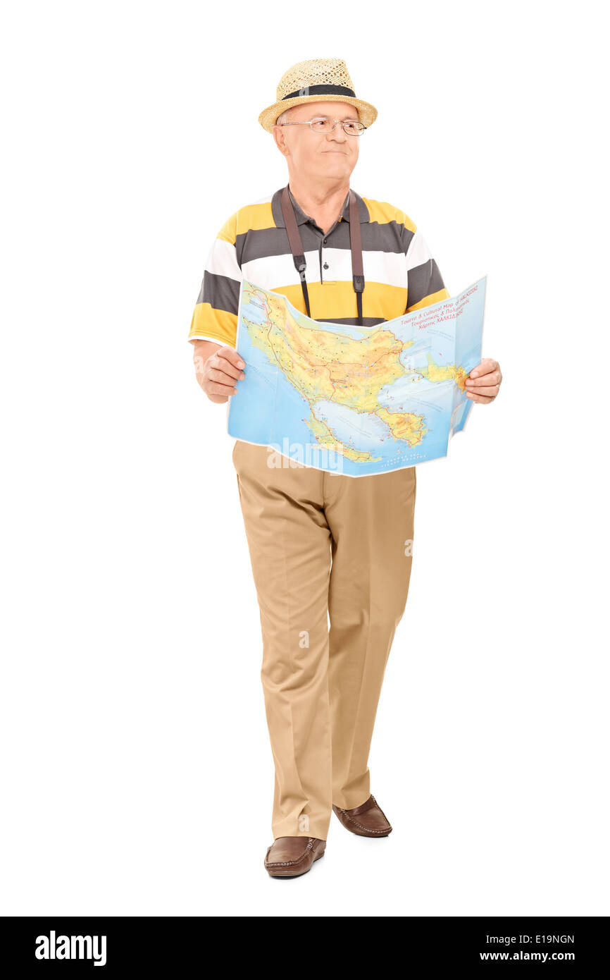 Full length portrait of a mature tourist walking with map in his hands Stock Photo