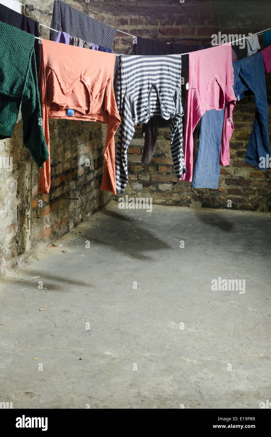 clothes on clothesline in old unhygenig basement Stock Photo Alamy