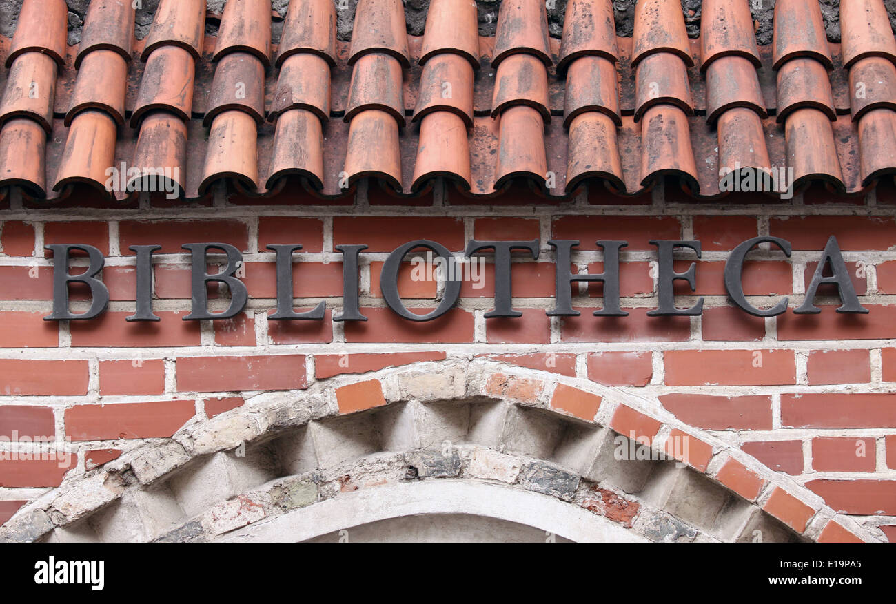 Library sign written in latin on red brick wall Stock Photo - Alamy
