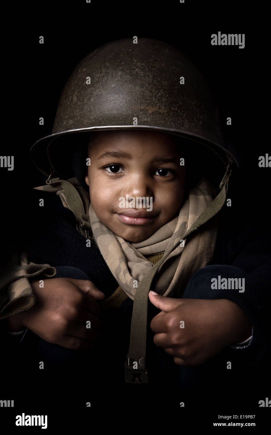 Young boy soldier in a dark background Stock Photo Alamy