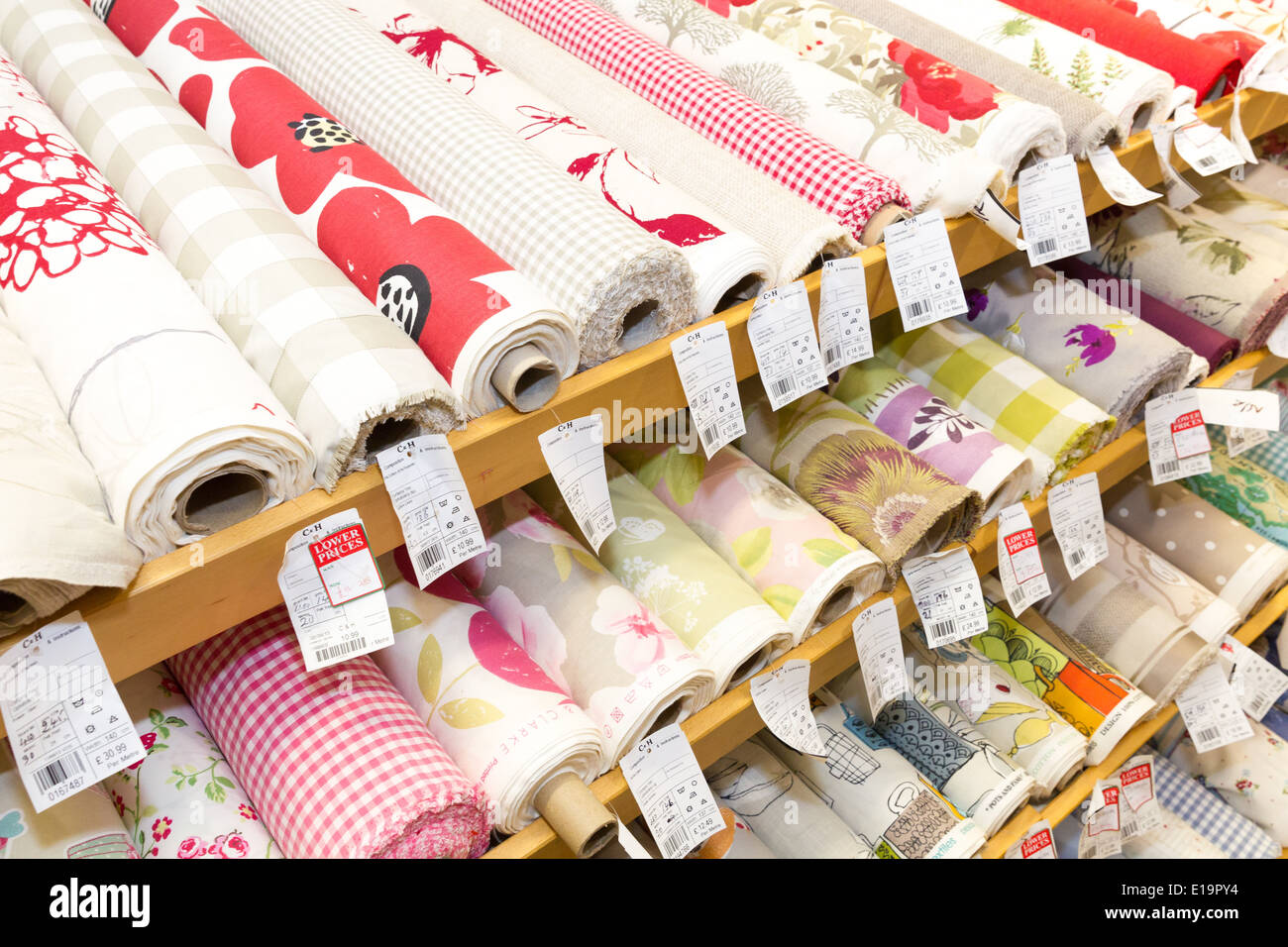 rolls of patterned sewing fabric shelf Stock Photo