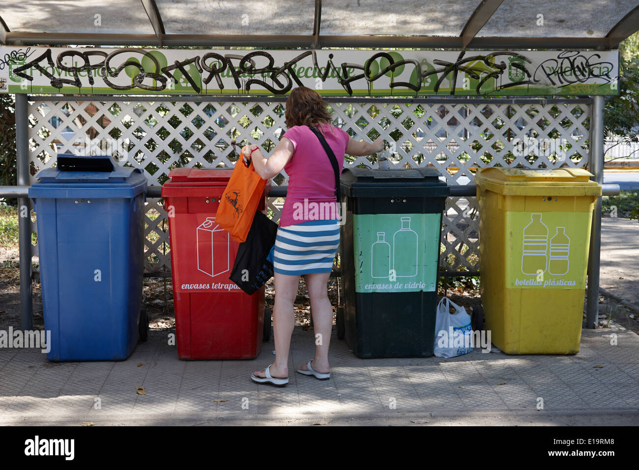 woman using recycling bins in communal area providencia Santiago 