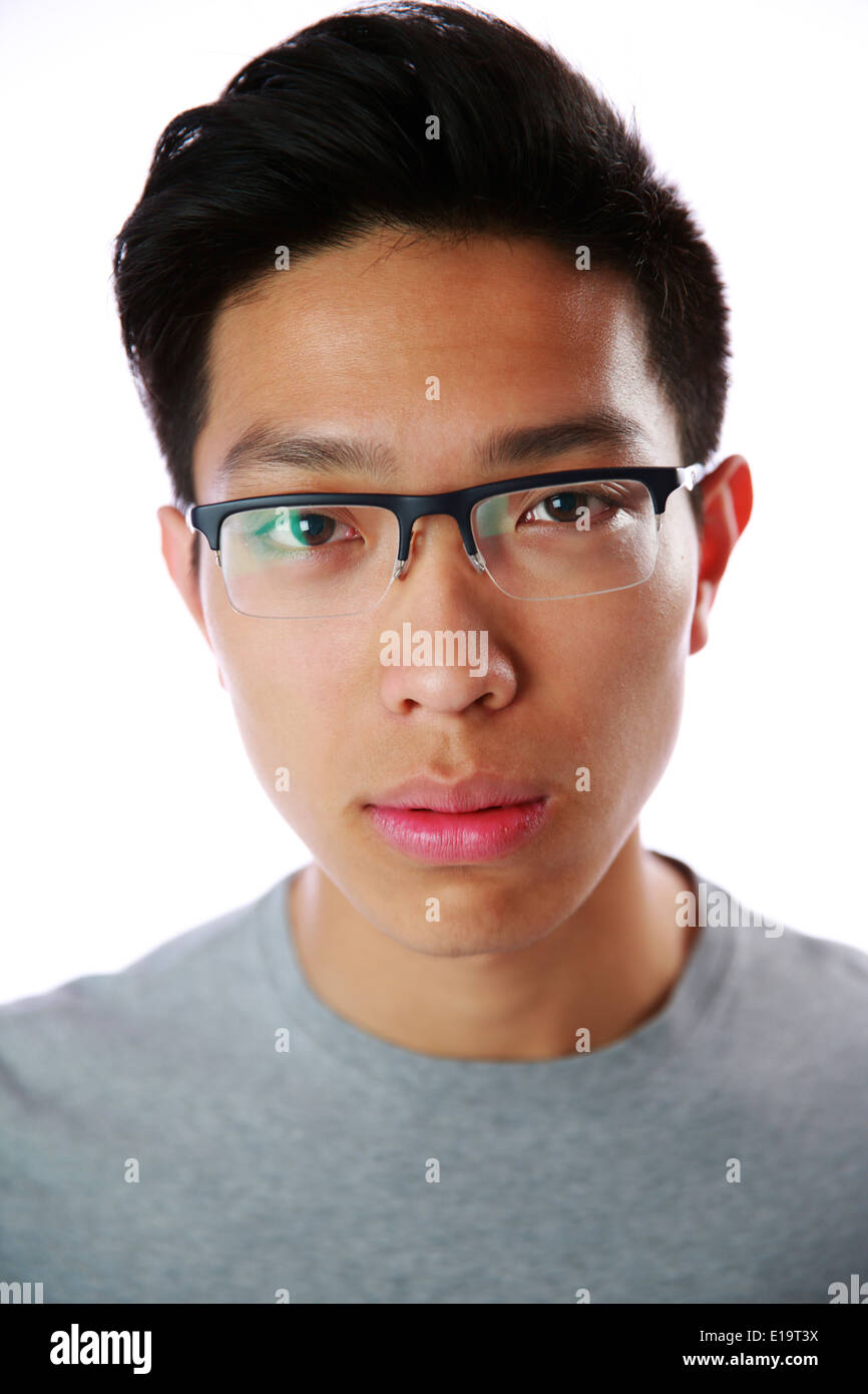 Closeup portrait of a young serious asian man over white background Stock Photo
