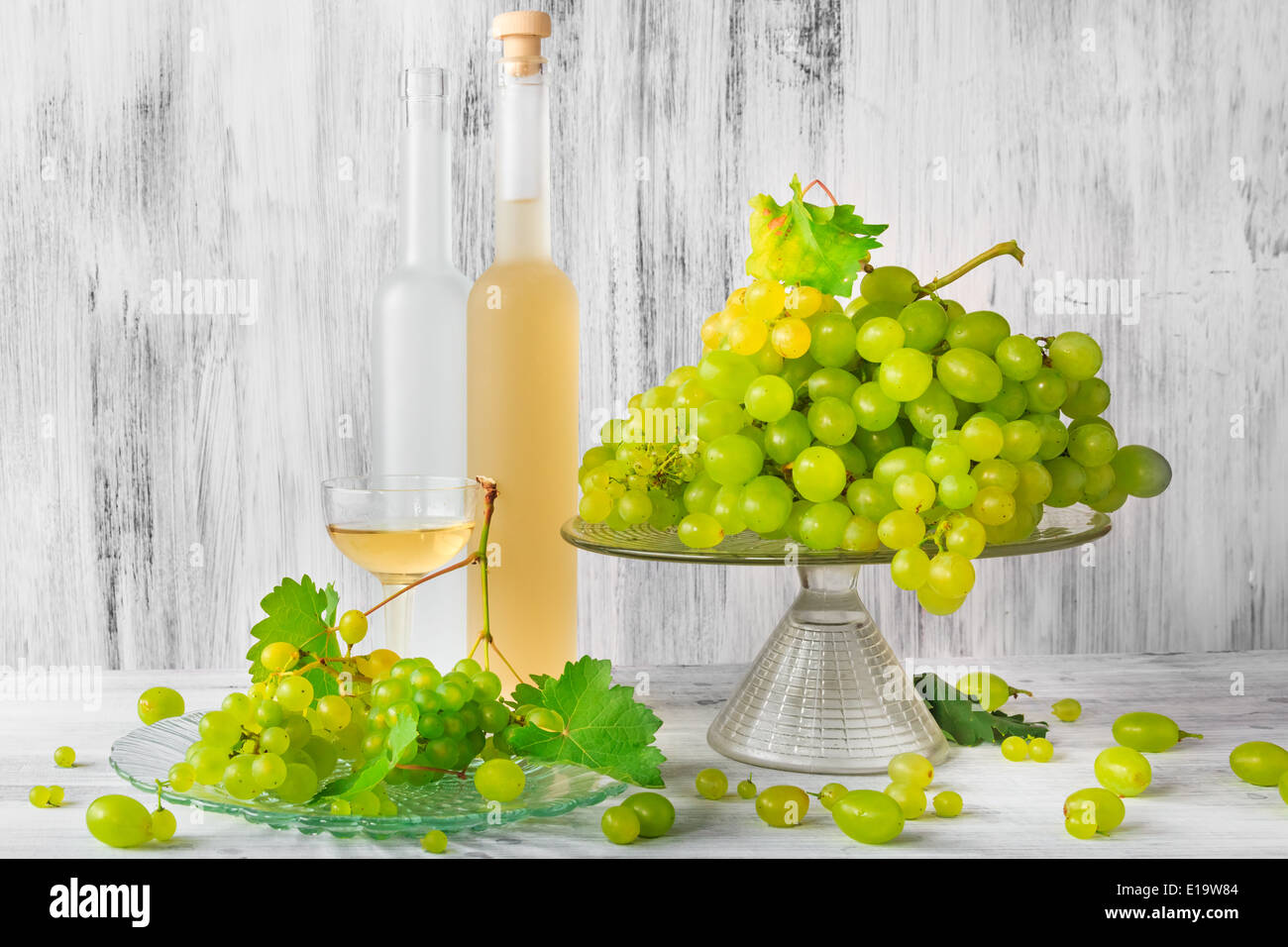 Still life with fruit and a bottle of wine grapes Stock Photo - Alamy