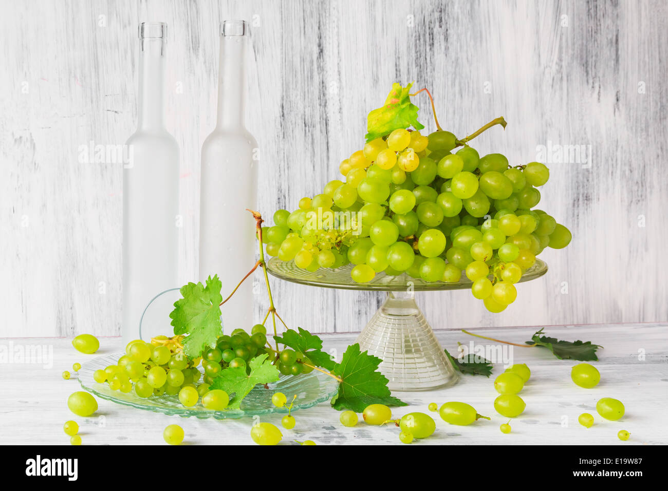 Still life with fruit and a bottle of wine grapes Stock Photo - Alamy