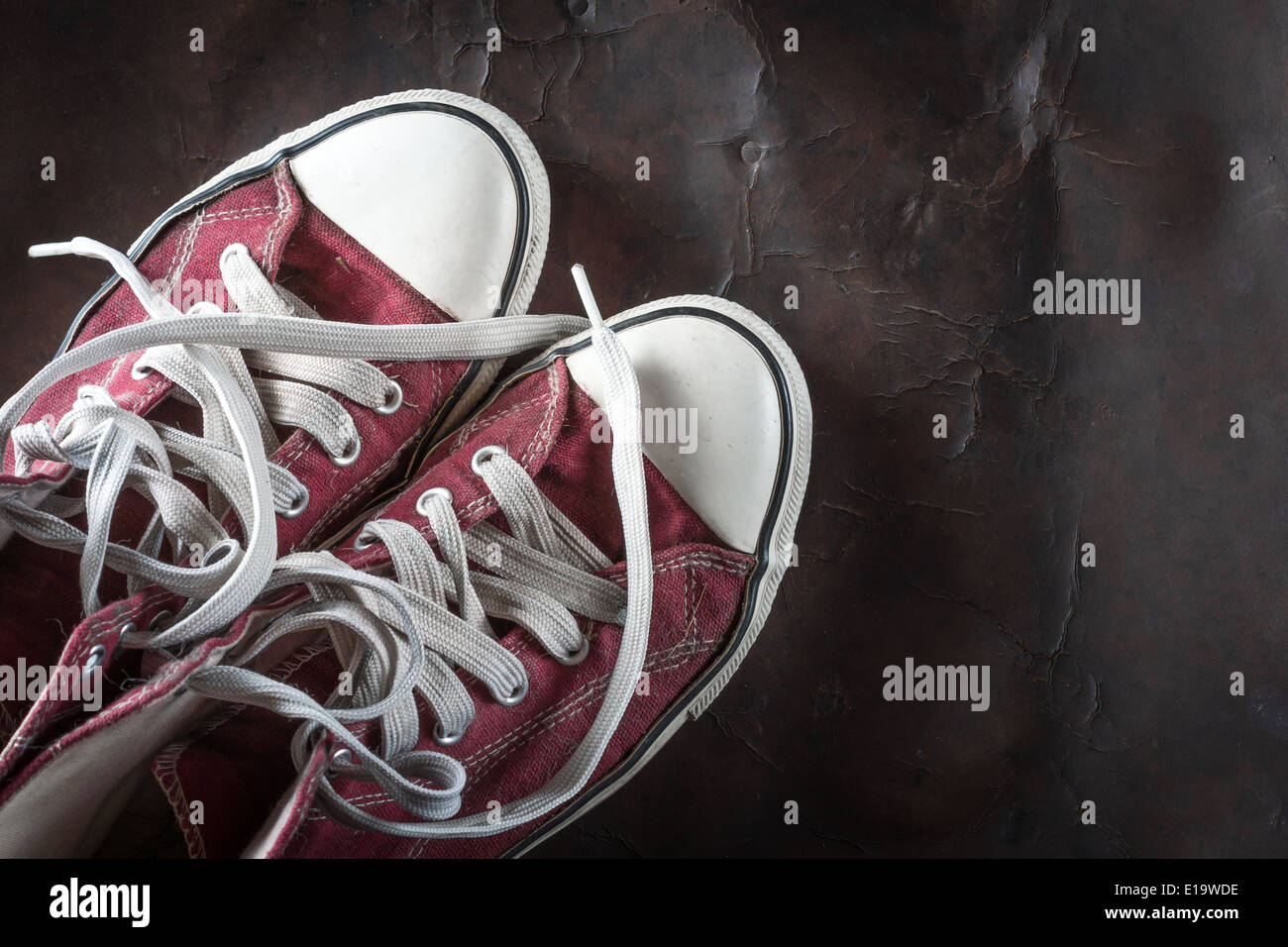 old red Sneakers on old Leather Stock Photo