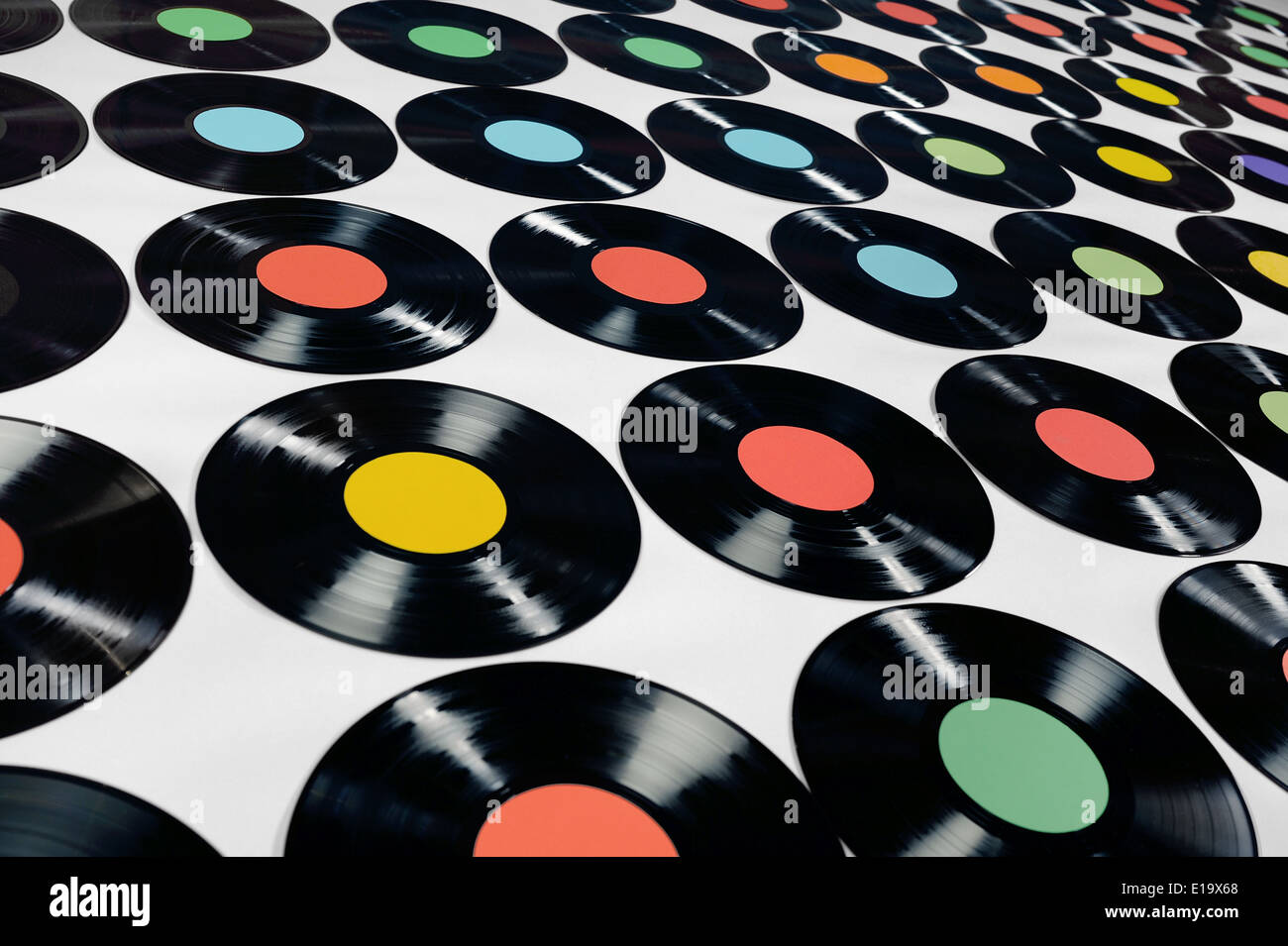 Colorful collection of vinyl records on grey background, angle view. Editable labels,  the image is suitable for background use. Stock Photo