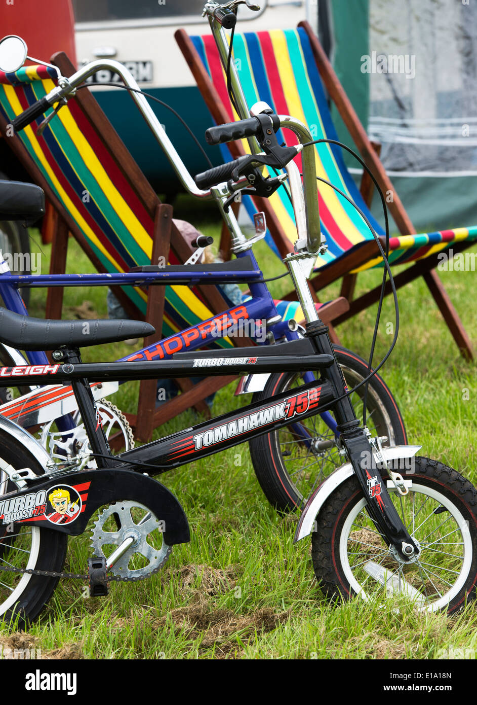 Raleigh Chopper and tomahawk bikes in front of deck chairs Stock Photo