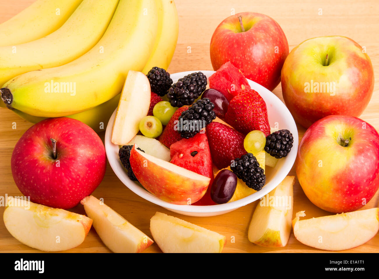 A bowl of fresh cut fruit with whole fruit Stock Photo Alamy