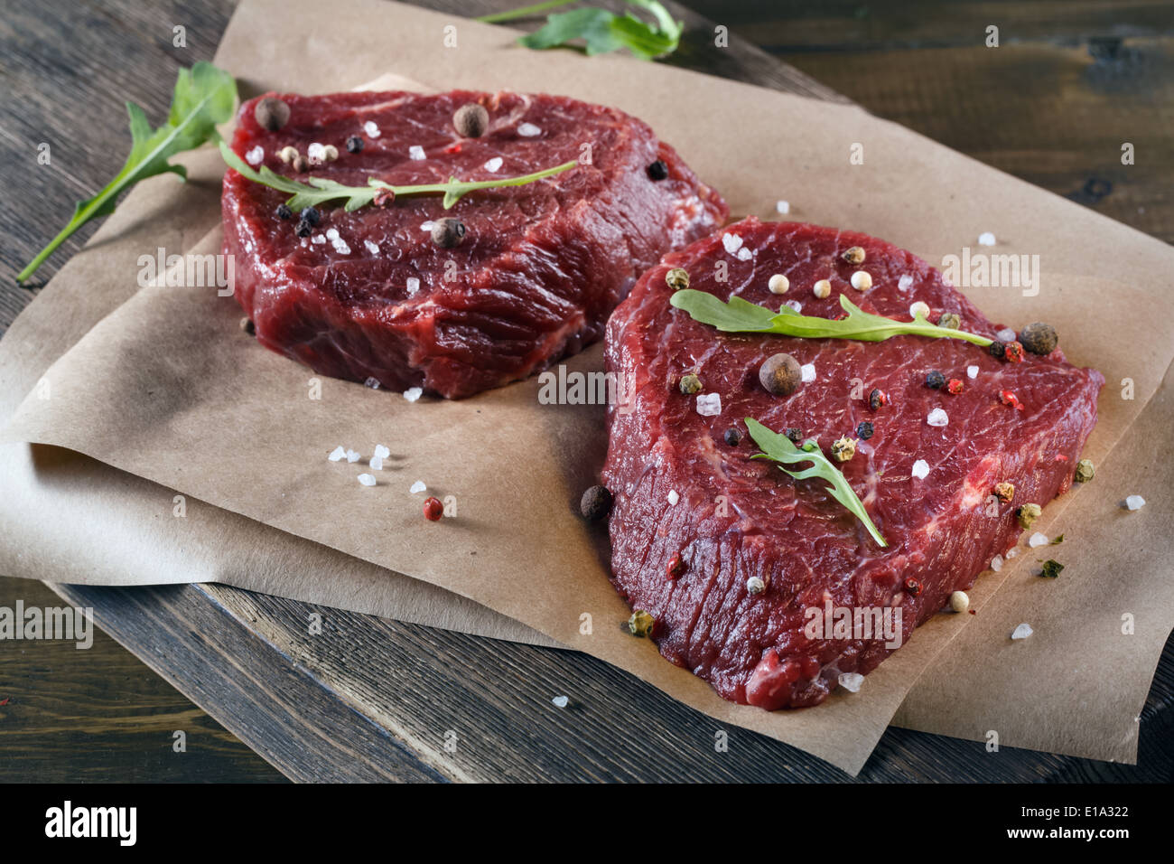 Succulent tender raw lean beef steaks lying Stock Photo