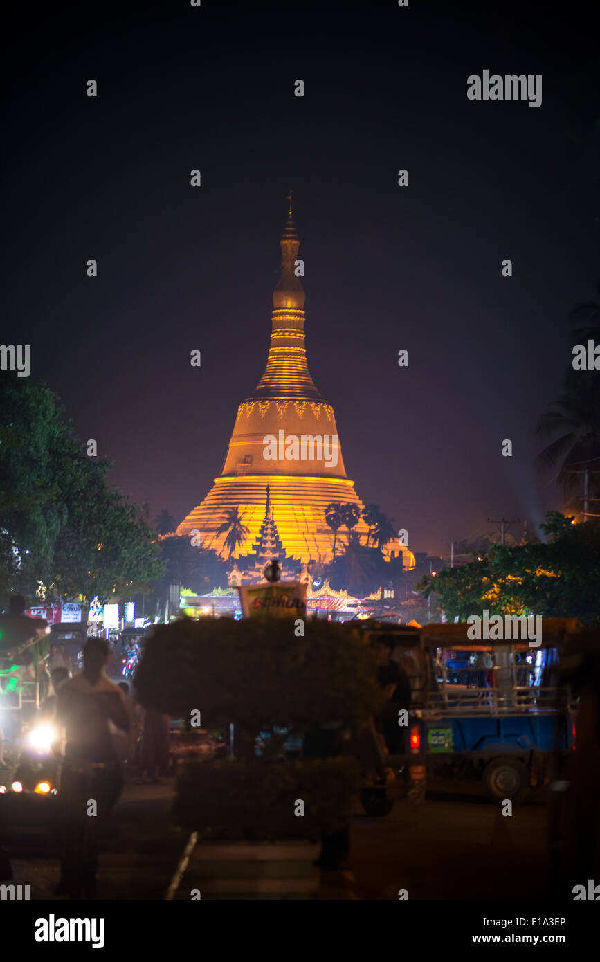 Shwemawdaw Paya stands 114 meters high above the sacred city of Bago, Myanmar and glows orange over the night sky. Stock Photo