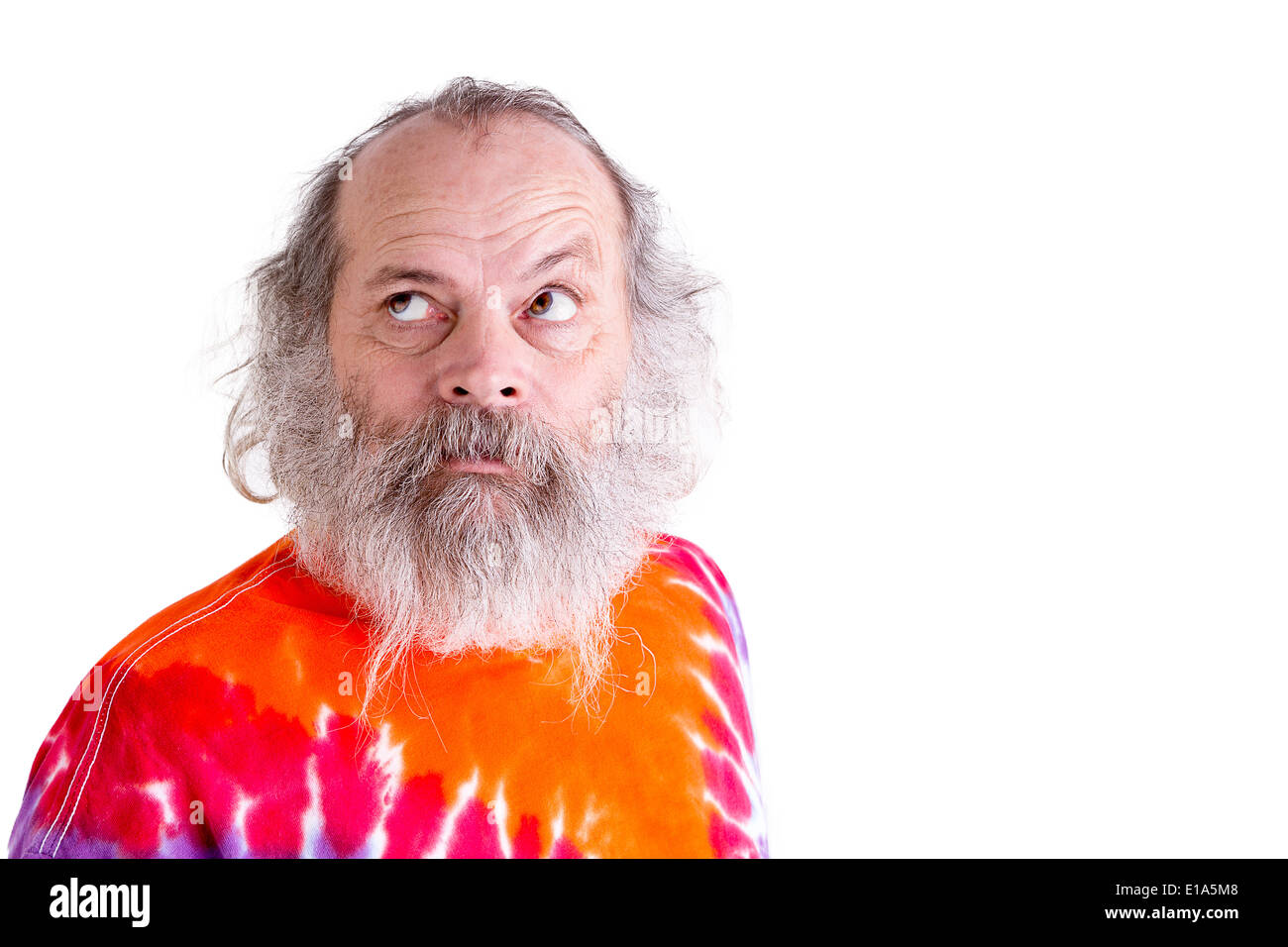 Searching for answers look coming from baby boomer generation senior male, he is looking up with his grey hair and long beard Stock Photo