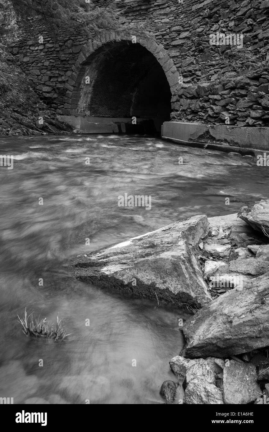 Black and white landscape of water flowing under a stone bridge Stock ...