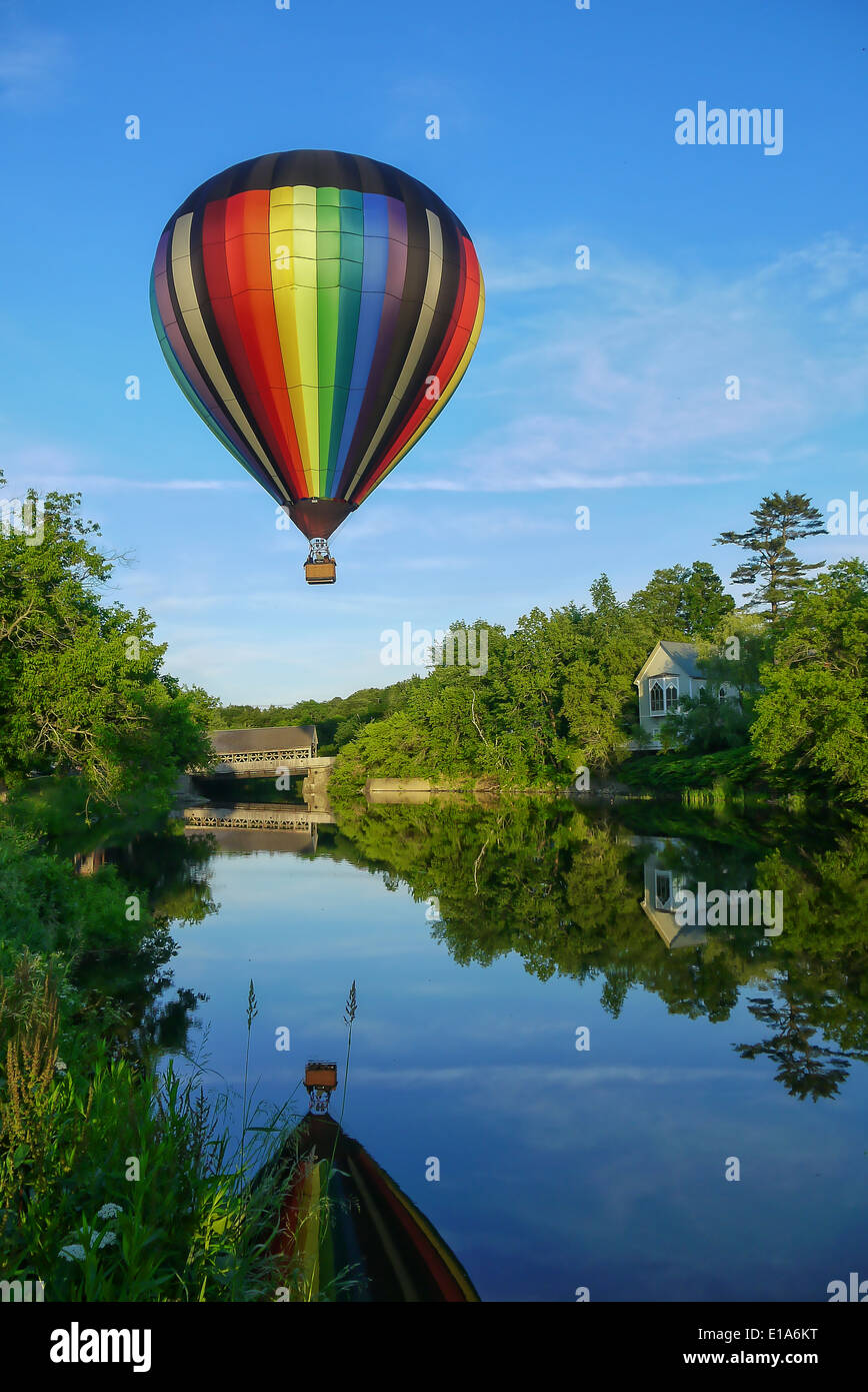 Hot air balloon over the covered bridge in Quechee, Vermont. Stock Photo