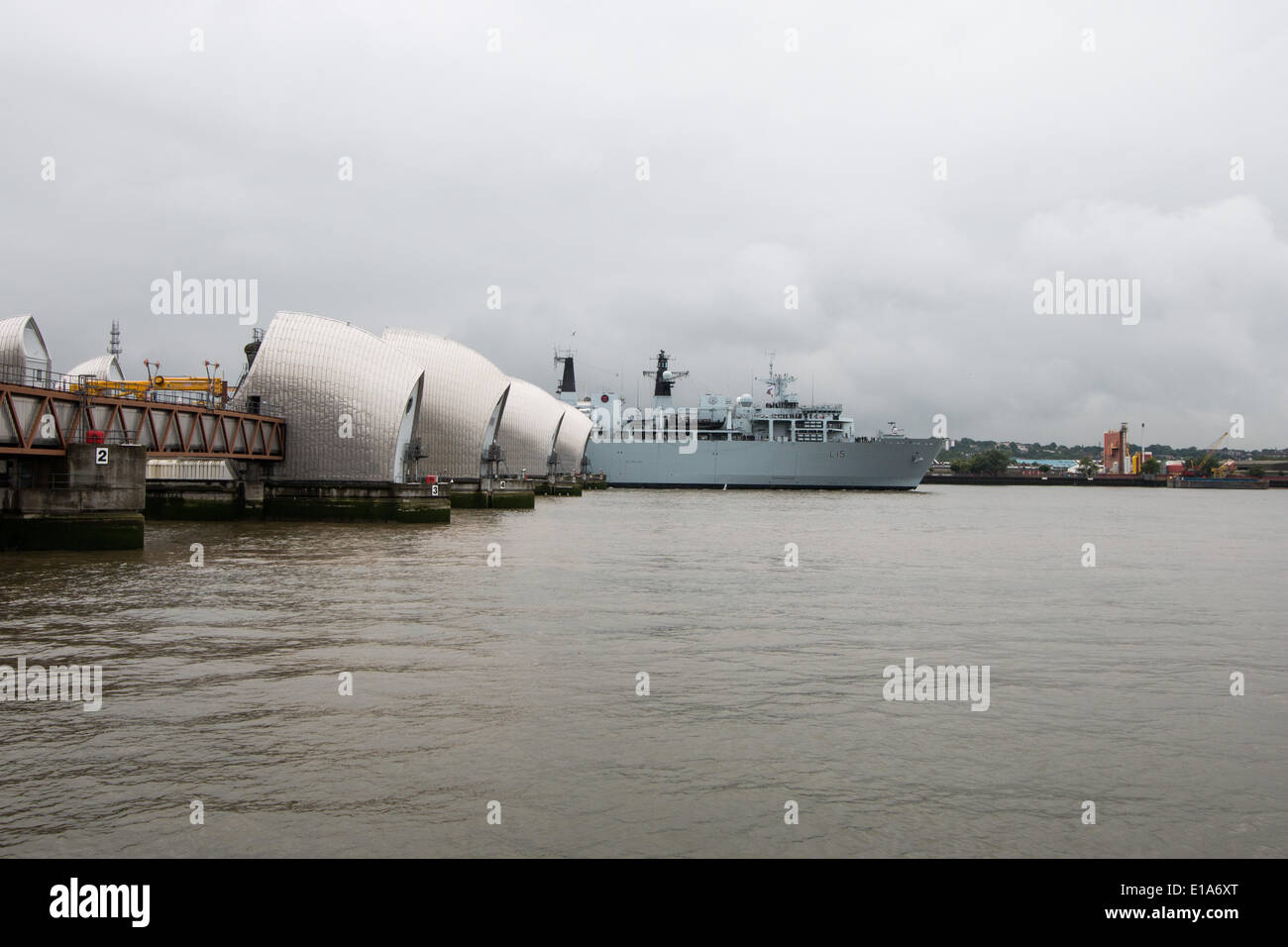 London, UK. 28th May 2014. HMS Bulwark, an Albion Class assault ship and flagship of the Royal Navy passes the Thames Barrier on its way to spend a few days at Greenwich to help mark the 350th anniversary of the Royal Marines Credit:  Steve Bright/Alamy Live News Stock Photo