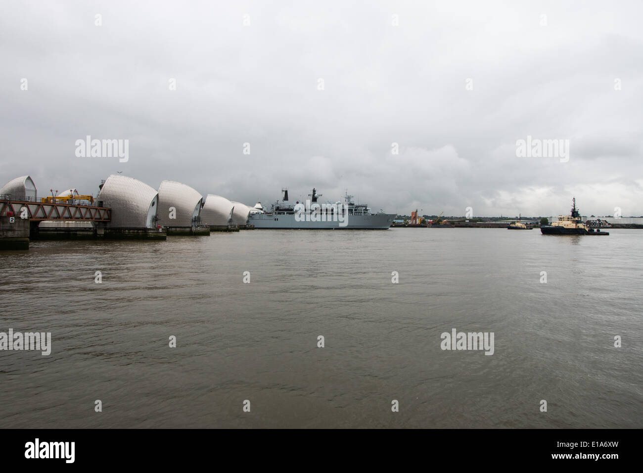 London, UK. 28th May 2014. HMS Bulwark, an Albion Class assault ship and flagship of the Royal Navy passes the Thames Barrier on its way to spend a few days at Greenwich to help mark the 350th anniversary of the Royal Marines Credit:  Steve Bright/Alamy Live News Stock Photo