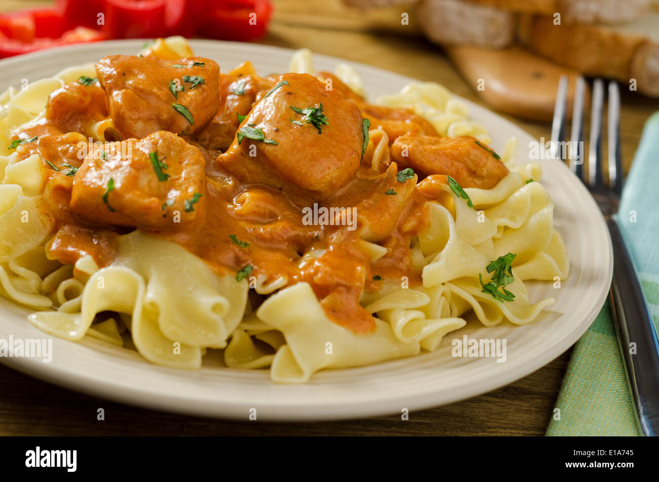 Chicken paprikash with egg noodles and red pepper Stock Photo Alamy