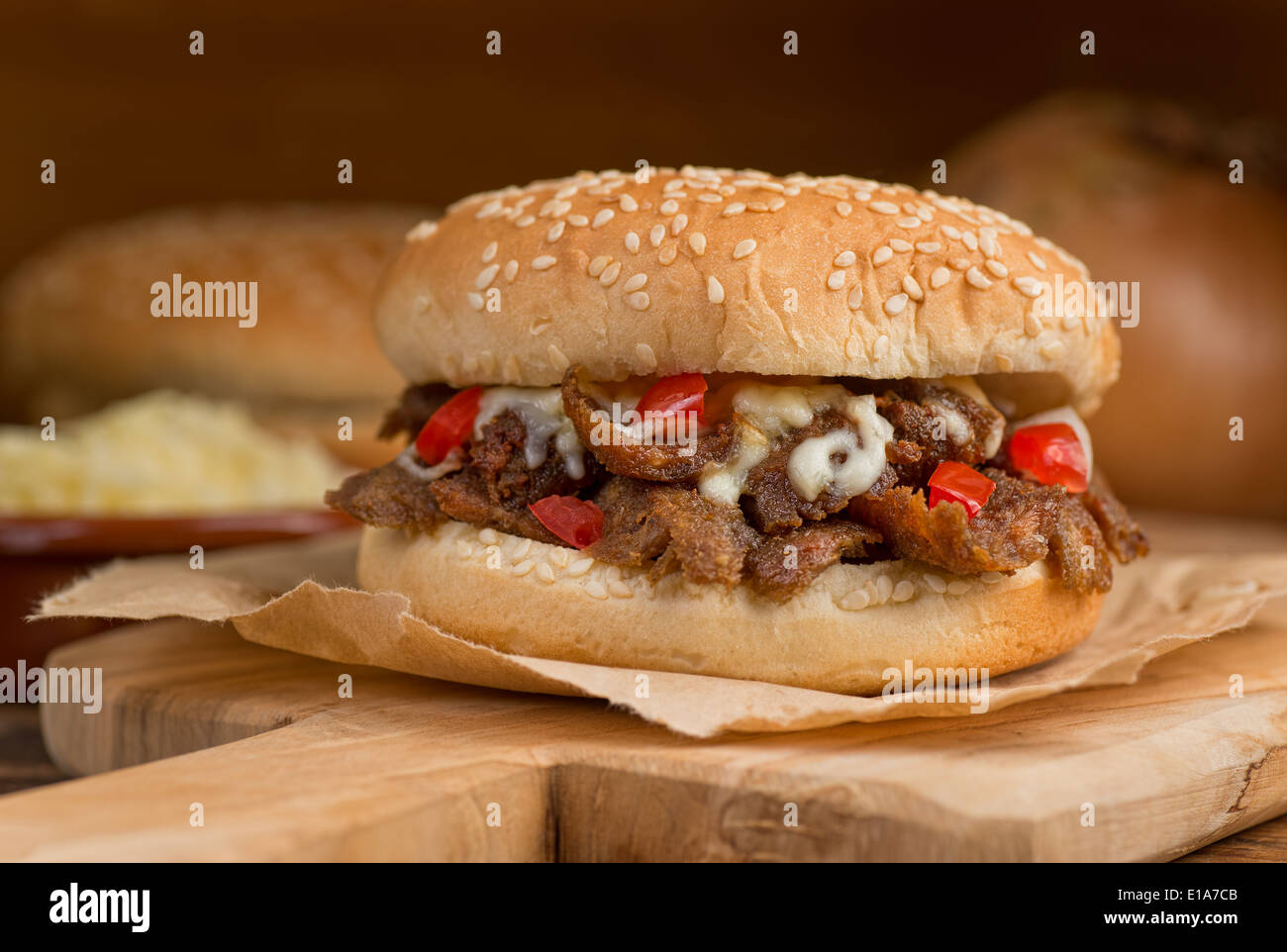 A donair burger with melted cheese, tomato, onion, and sauce. Stock Photo