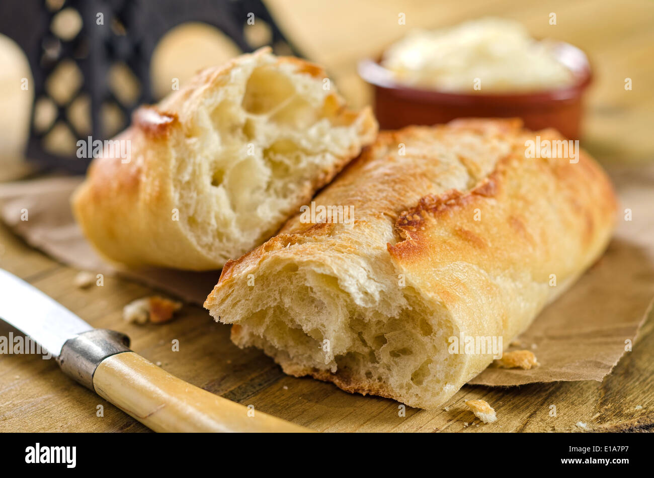 Crisp and chewy french bread baguette with butter. Stock Photo