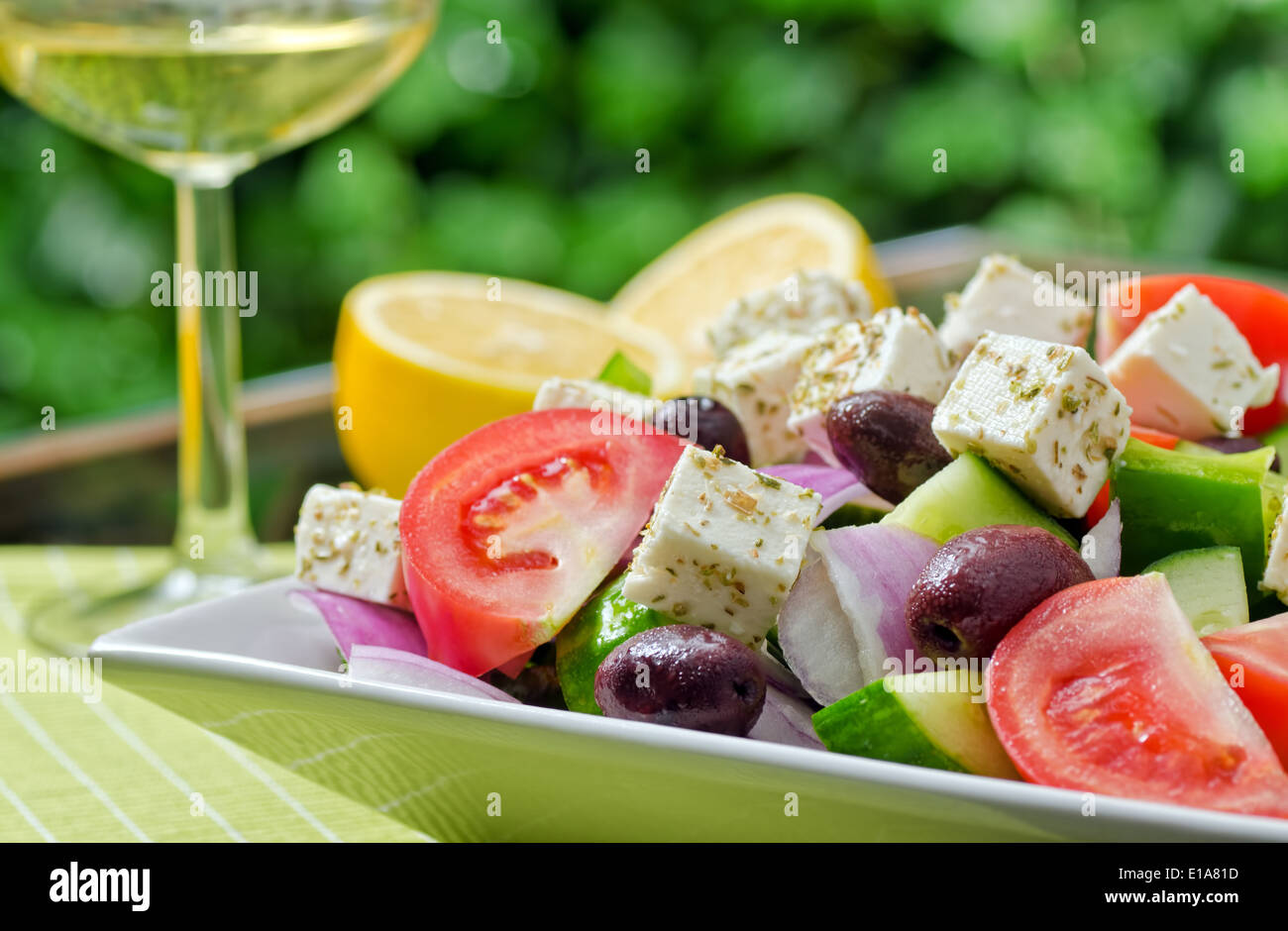 A summer fresh greek salad with tomato, cucumber, green pepper, red onion, kalamata olive, and feta cheese. Stock Photo