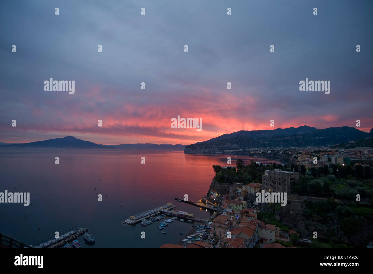 A fiery sunrise with red sky over Sorrento, the Bay of Naples and Mount Vesuvius, an active volcano, Italy Stock Photo