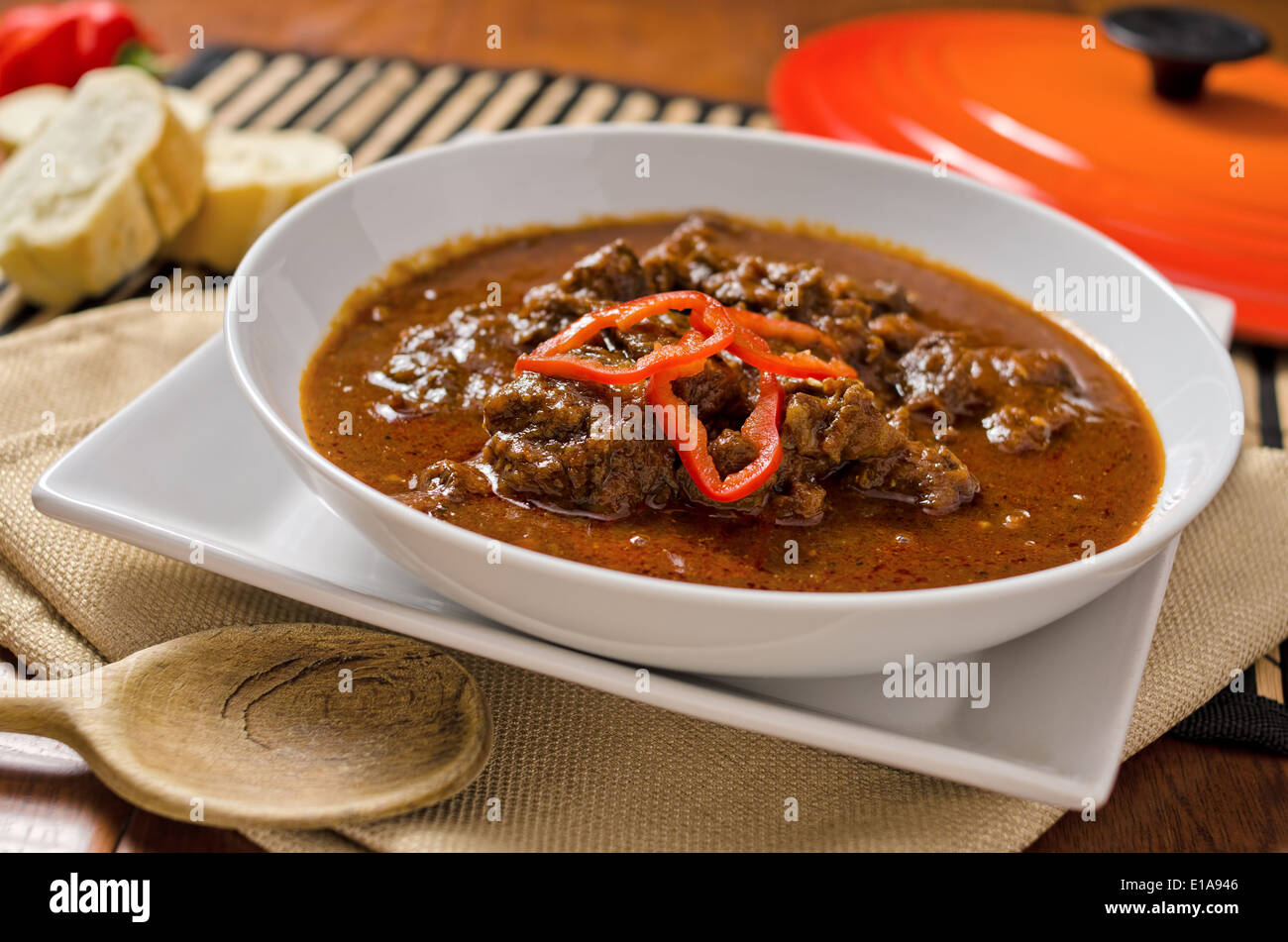 A bowl of authentic hungarian goulash with paprika and peppers. Stock Photo