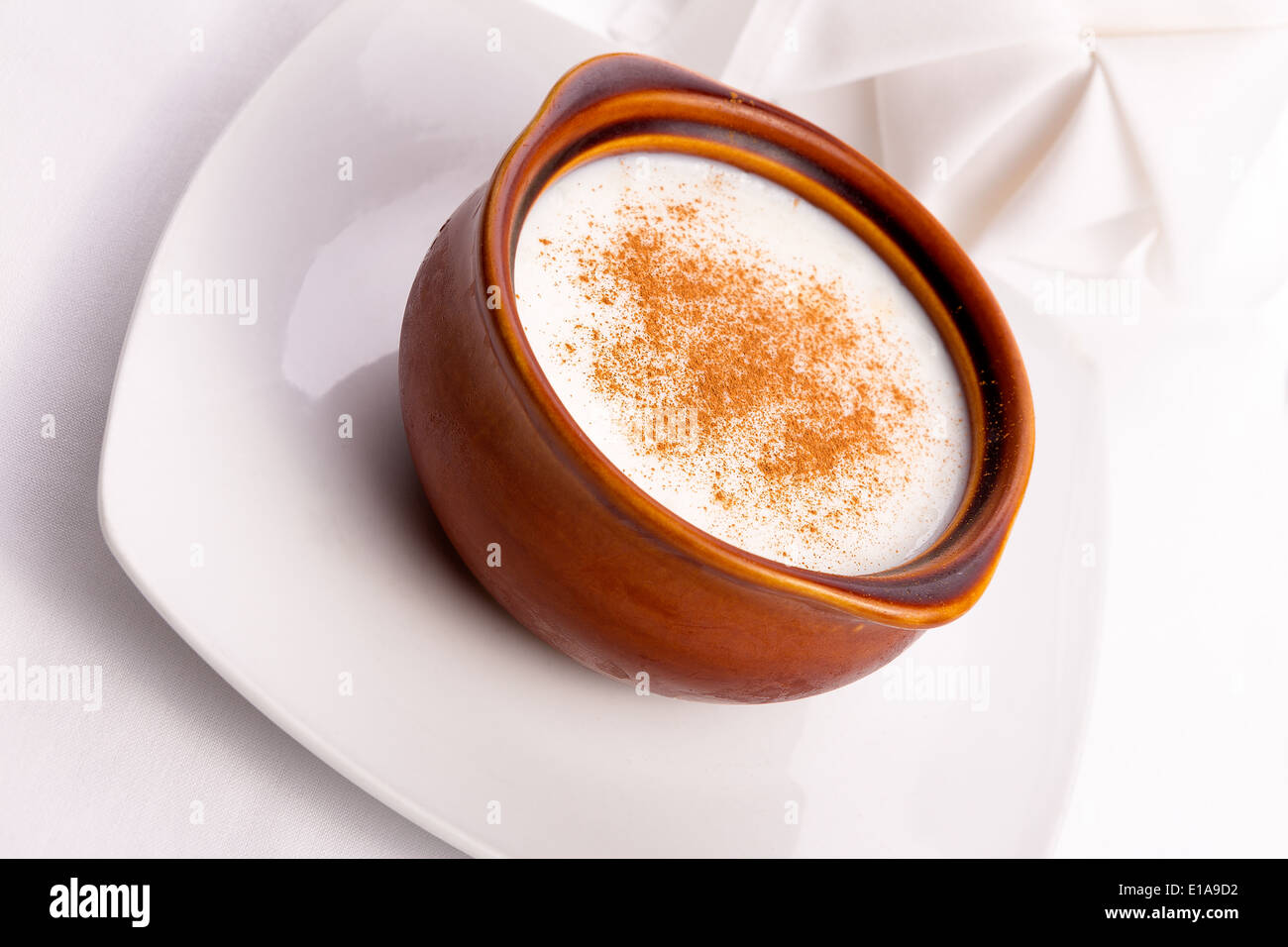 Plain rice pudding with cinnamon on top of in in brown casserole Stock Photo
