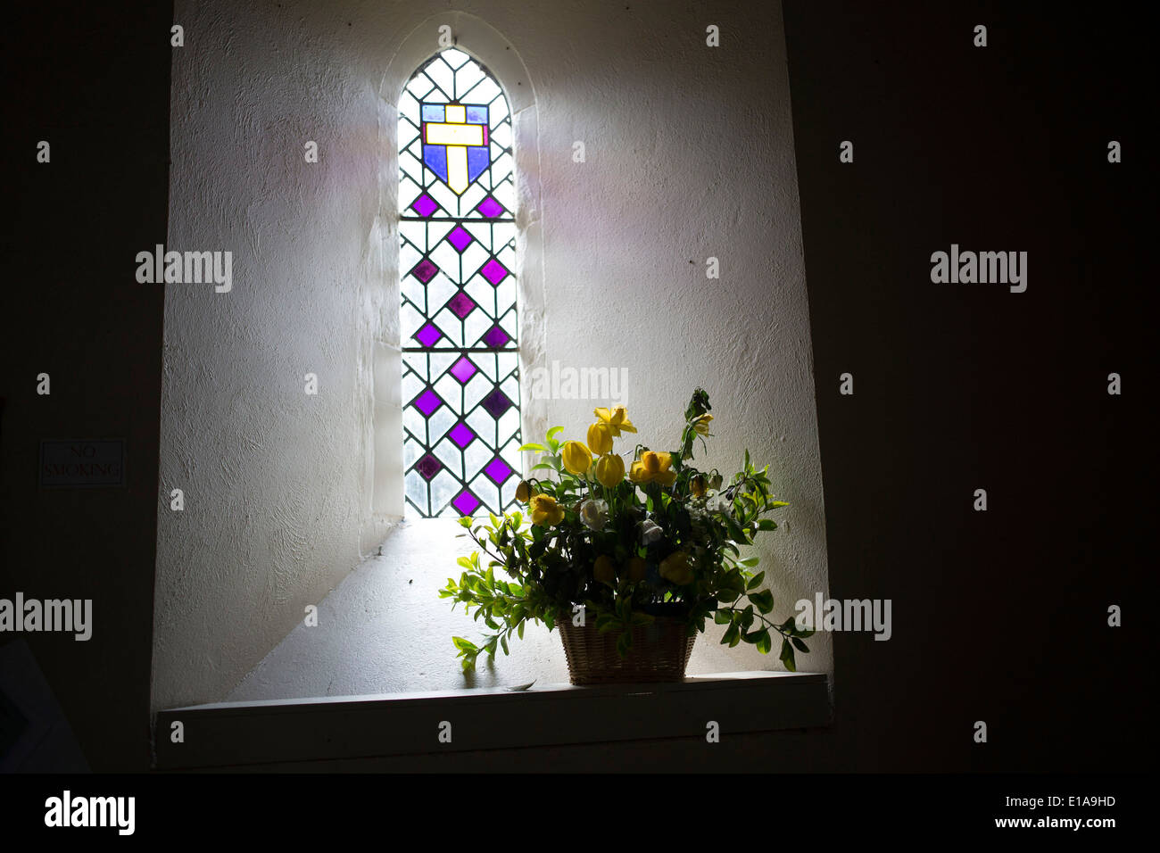 Stained glass window interior with flowers in St Bartholomew church in