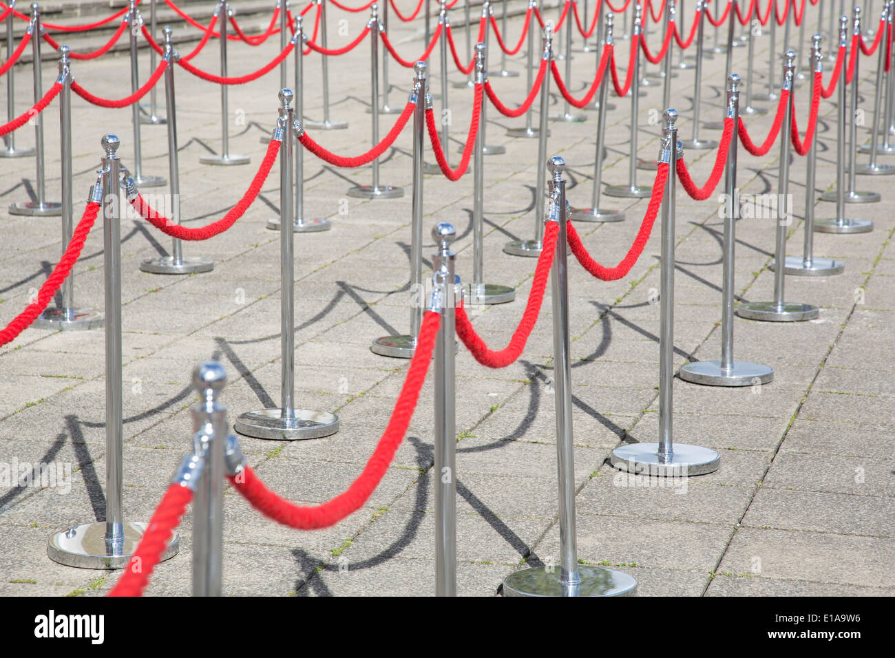 Red rope barriers cordon off an area where a queue will form to help