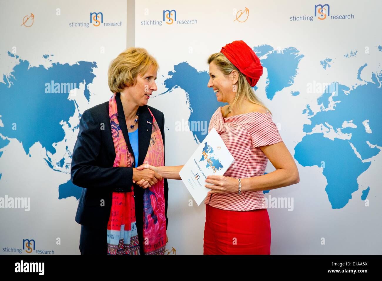 Voorschoten, The Netherlands. 28th May, 2014. Queen Maxima (R) visits foundation MS Research at World MS Day in Voorschoten, The Netherlands, 28 May 2014. The Queen received the first Dutch version of the International MS (multiple sclerosis) Atlas. Photo: Patrick van Katwijk/NO WIRE SERVICE/dpa/Alamy Live News Stock Photo