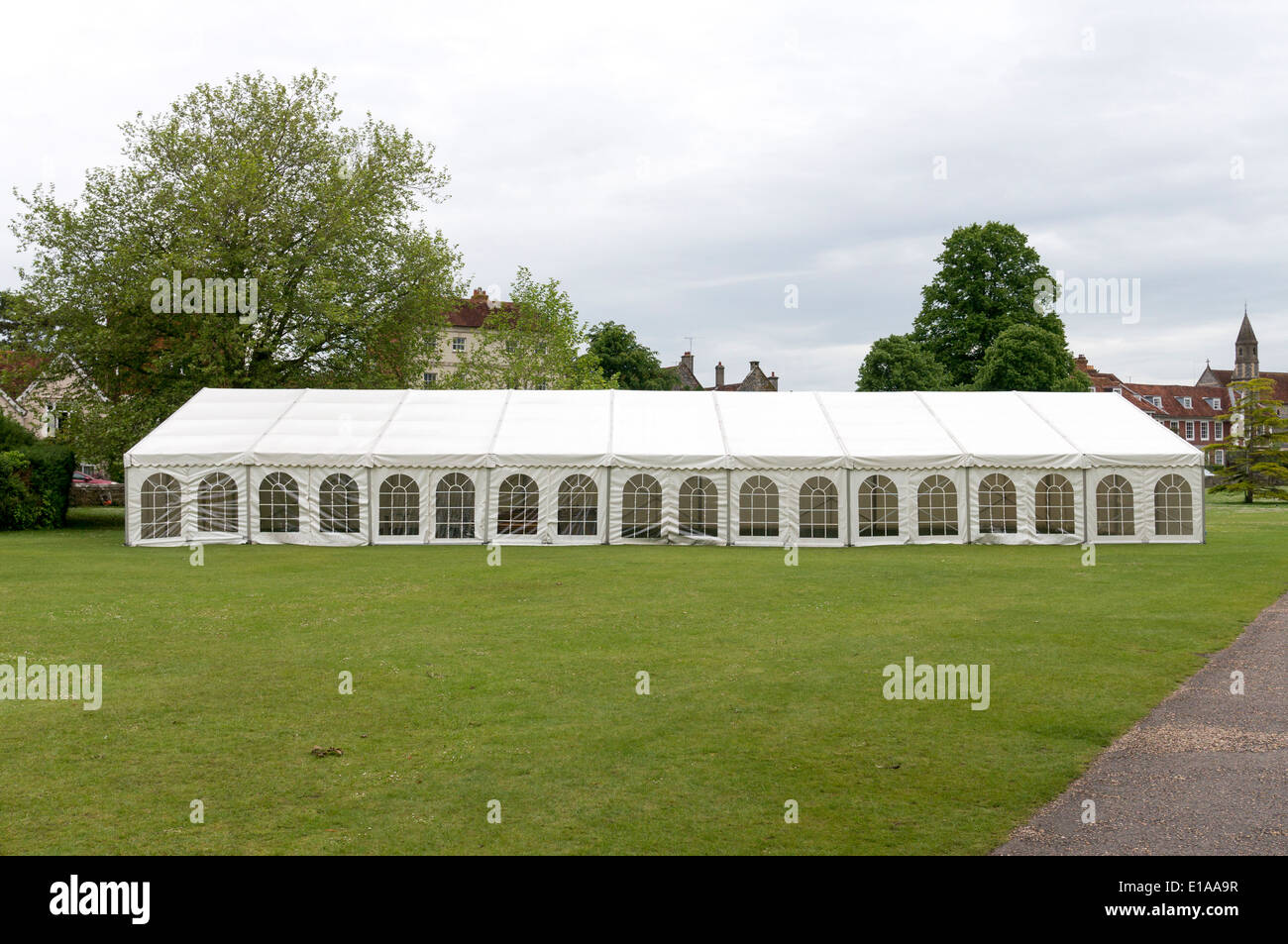 Long white canvas marquee tent on grass Stock Photo - Alamy