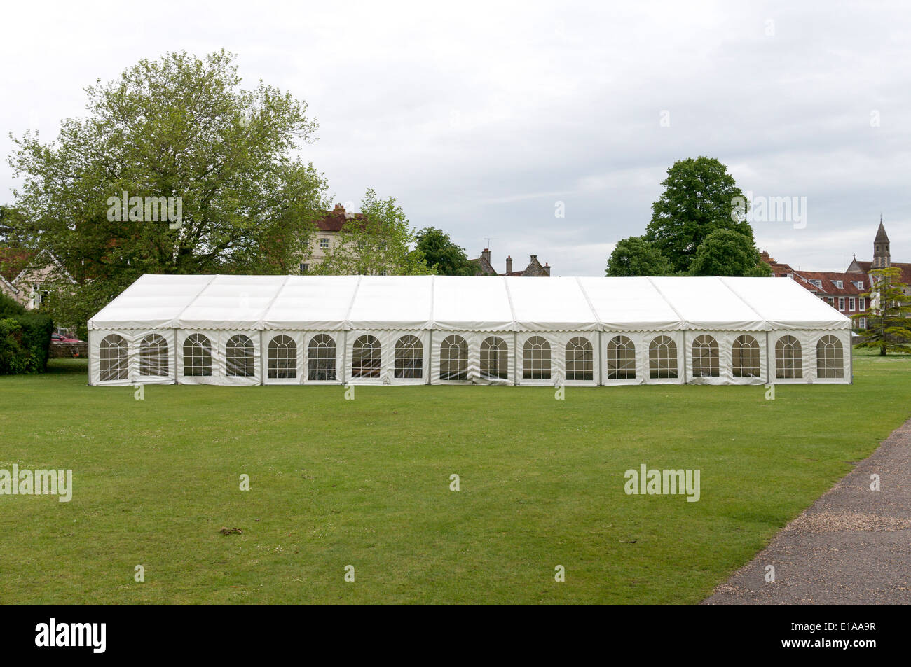 Long white canvas marquee tent on grass Stock Photo