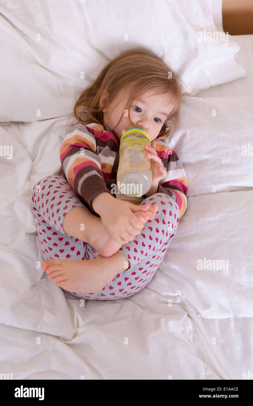 Toddler girl getting ready to sleep, having her drink before fall asleep Stock Photo Alamy