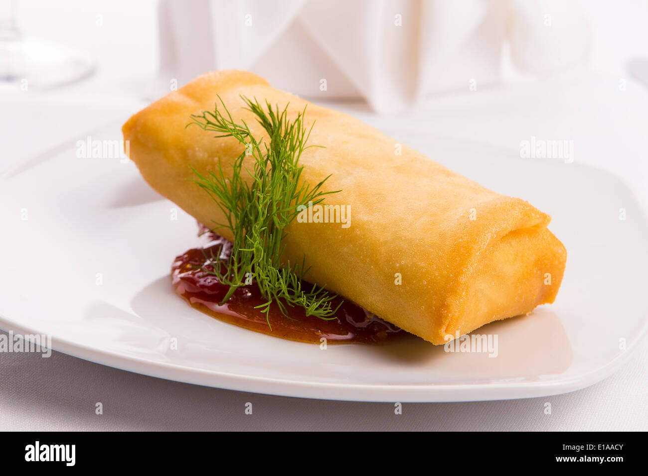 Classy eggroll served on spicy sauce along with dill Stock Photo